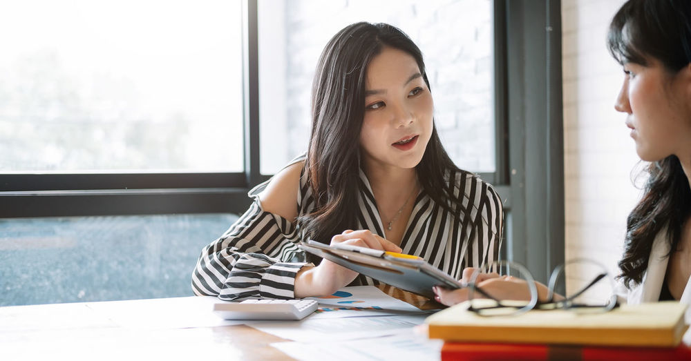 Businesswoman brainstorming while sitting at office