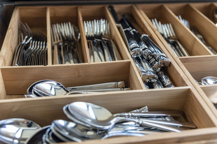 Interior of utensil drawer organized silverware.