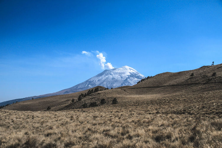 Idyllic shot of volcano and landscape against sky