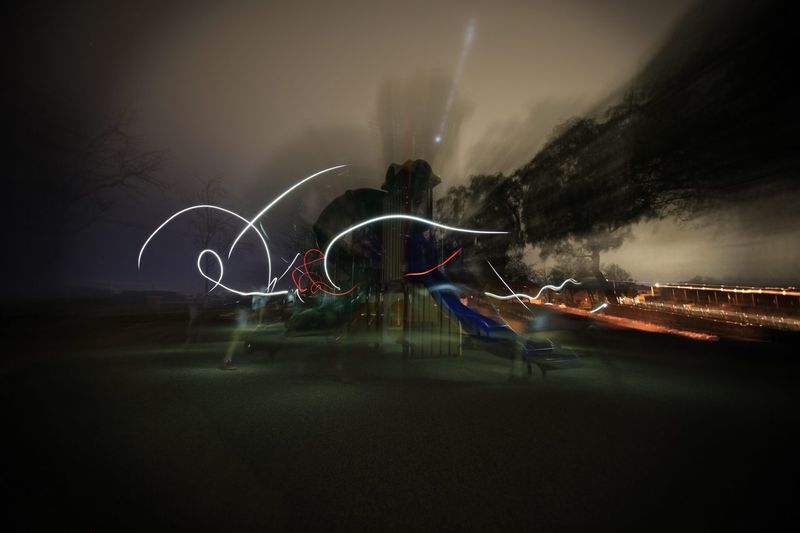 Digital composite image of light trails against sky