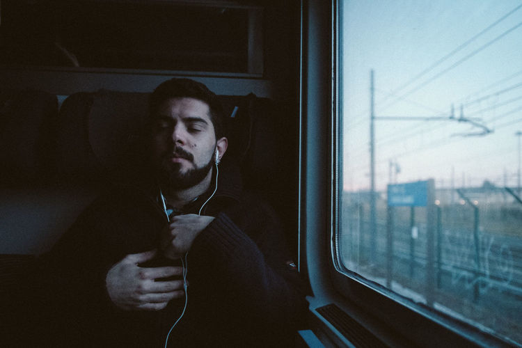 Man looking through train window