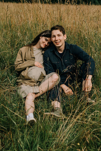 Smiling young couple on field