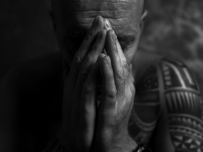 Close-up of hands covering face