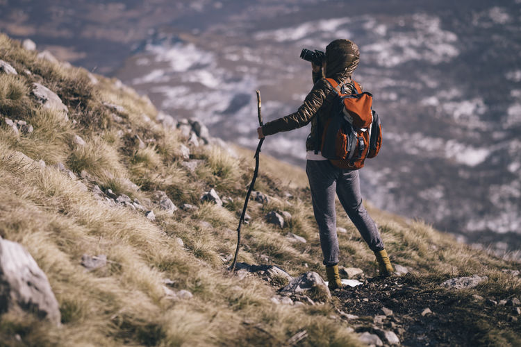 Woman photographing mountains