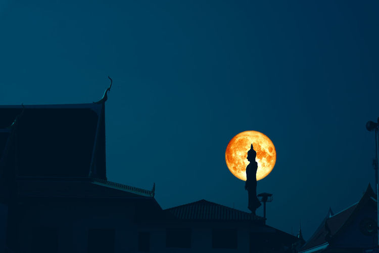 Sunday buddha and blood moon on night sky in the asanha bucha day,