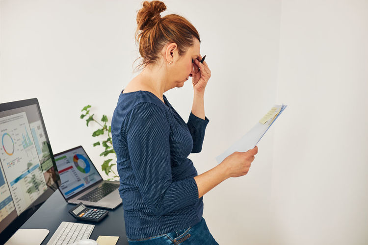 Woman entrepreneur feeling tired and stressed. worried businesswoman thinking hard in office