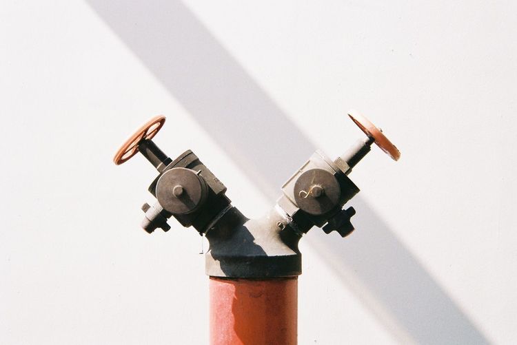 Low angle view of metal against white background