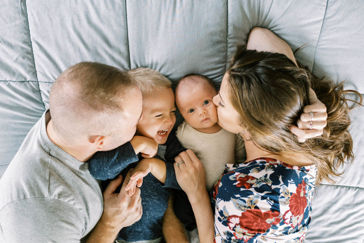 Portrait of a young family with a newborn baby boy and toddler