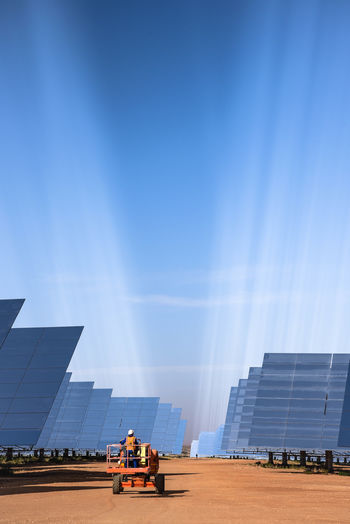 Panoramic view of buildings against blue sky