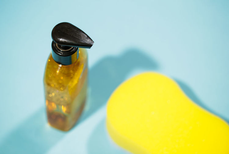 Close-up of yellow bottle on table