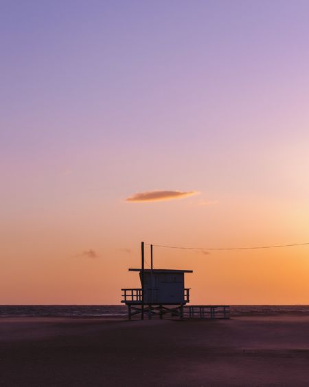 Scenic view of beach against sky during sunset