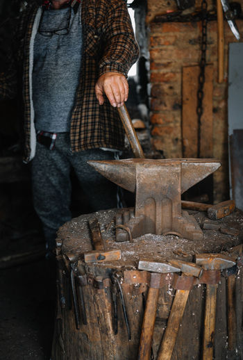 Man working on blacksmith workshop