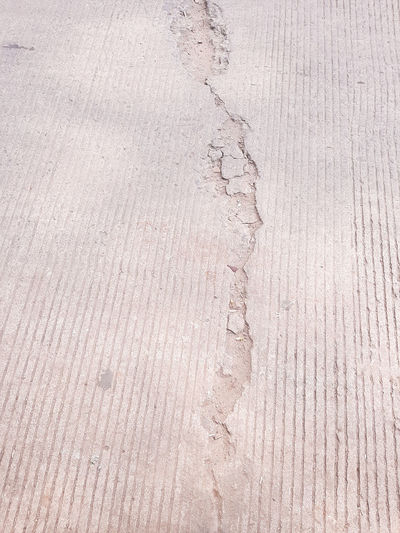  a broken asphalt road with line pattern in the background