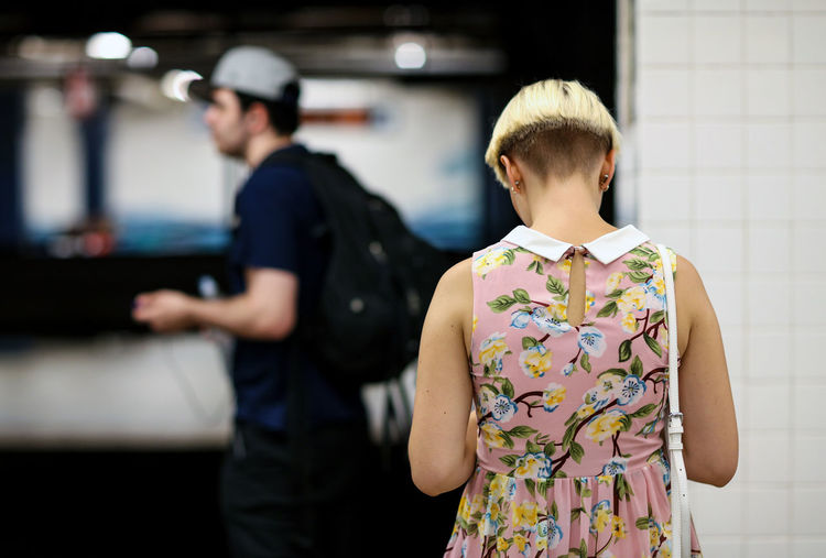 Rear view of woman at railway station