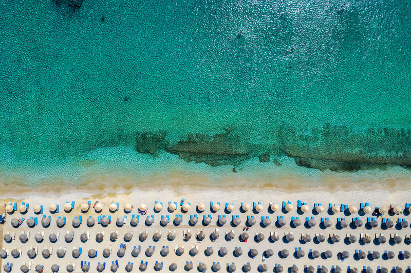 Aerial view of sea and lounge chairs
