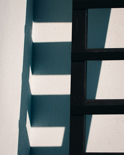 Shadow of ladder on wall