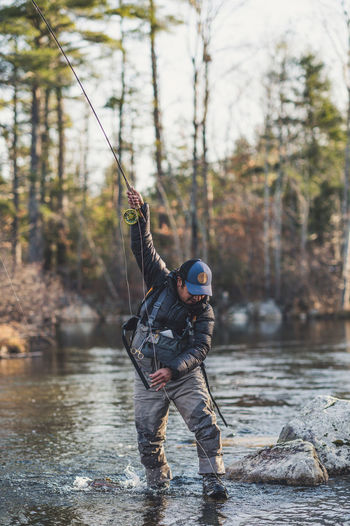 A man gets wrapped up in his flyline while fighting a fish in maine