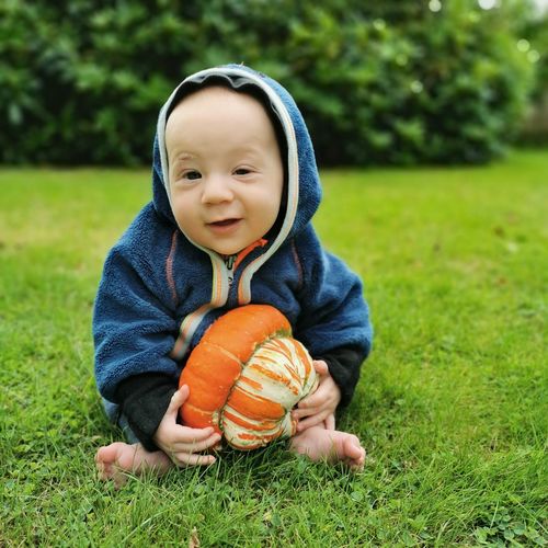Portrait of cute baby boy on grass