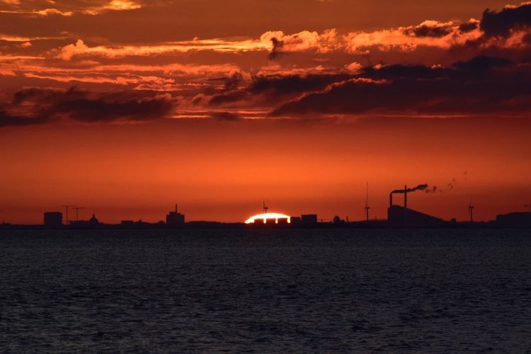 View of sea against cloudy sky during sunset