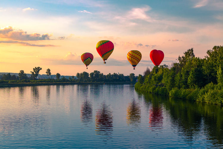 Hot air balloons against sky during sunset