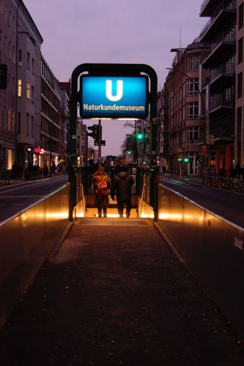 People on illuminated city street at night