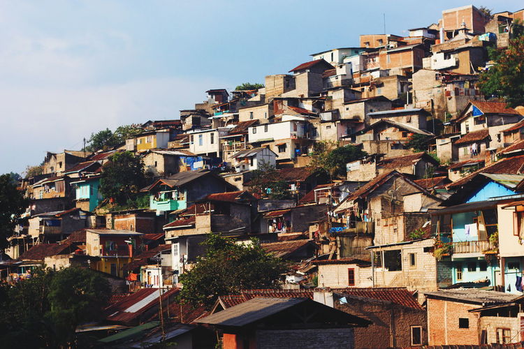 Houses in town against sky