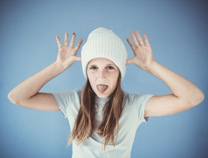 Portrait of young woman wearing hat