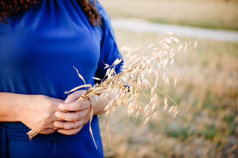 Midsection of woman holding oat