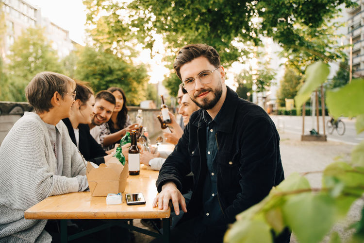 YOUNG FRIENDS SITTING ON TABLE