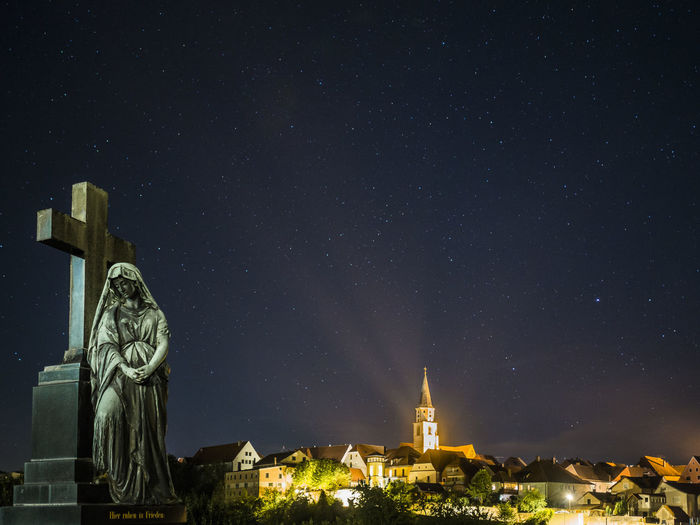 Germany, bavaria, nabburg, tombstone at night with illuminated town in background