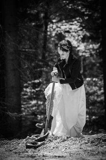 Portrait of young woman after wedding in wedding dress  in forest