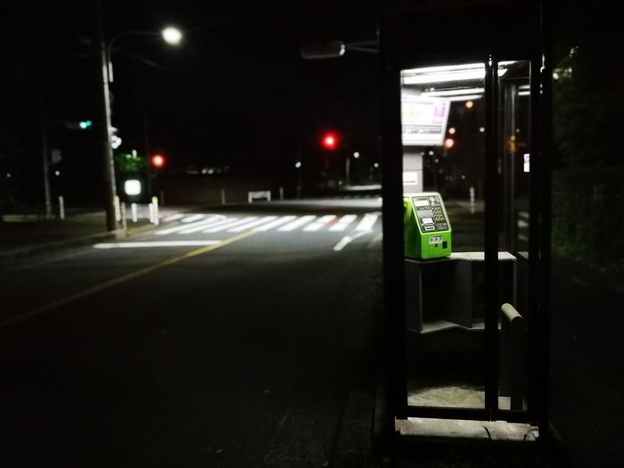 Illuminated road sign at night