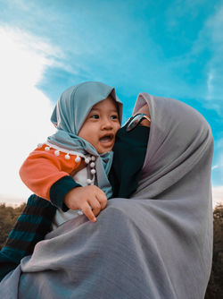 The happiness of a woman wearing a hijab when she is with her daughter