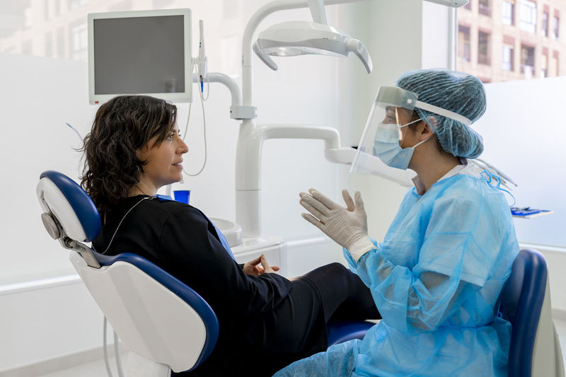 Doctor with patient discussing in operating room at maxillofacial clinic