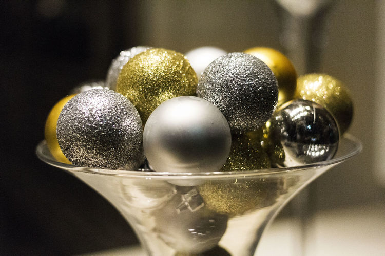Close-up of shiny decoration balls in glass bowl