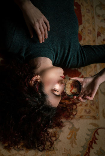 High angle view of woman lying on table at home