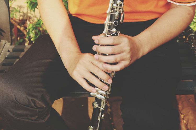 Midsection of man playing music