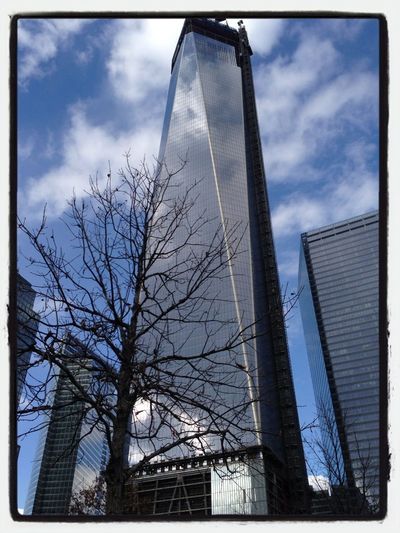 Low angle view of modern building against cloudy sky