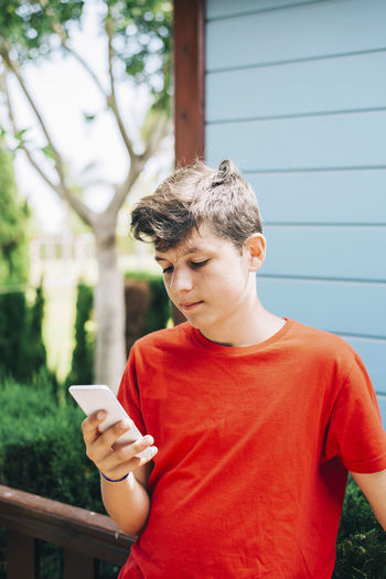Young man using mobile phone outdoors