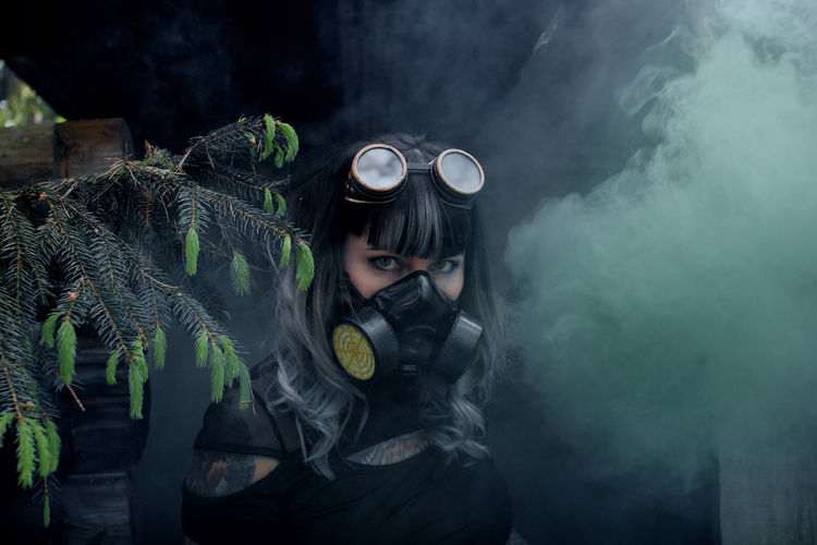 Portrait of woman wearing gas mask