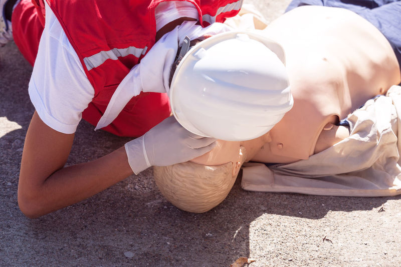 Paramedic performing cpr on dummy