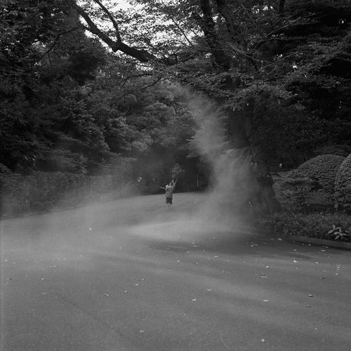 Man riding motorcycle on road in forest