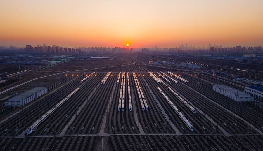 Aerial view of train on tracks against sky during sunset