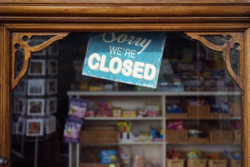 Close-up of closed sign in store