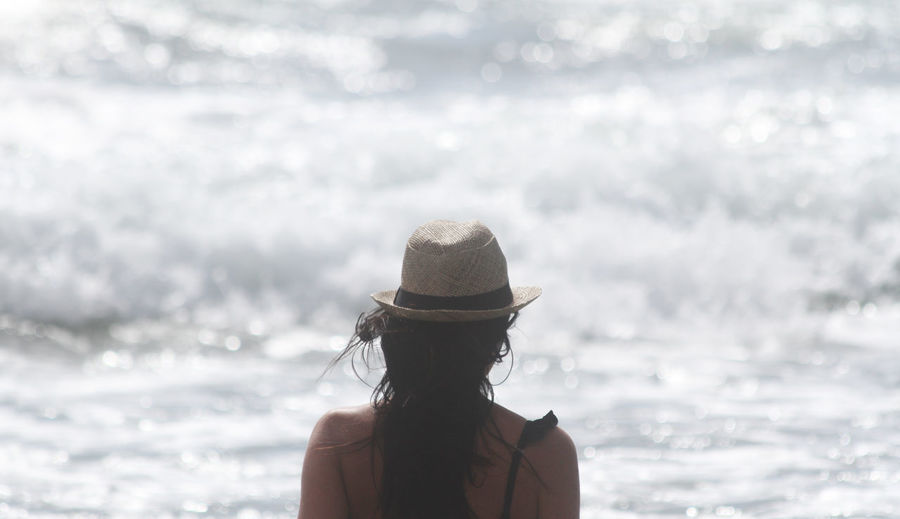Woman wearing hat at sea