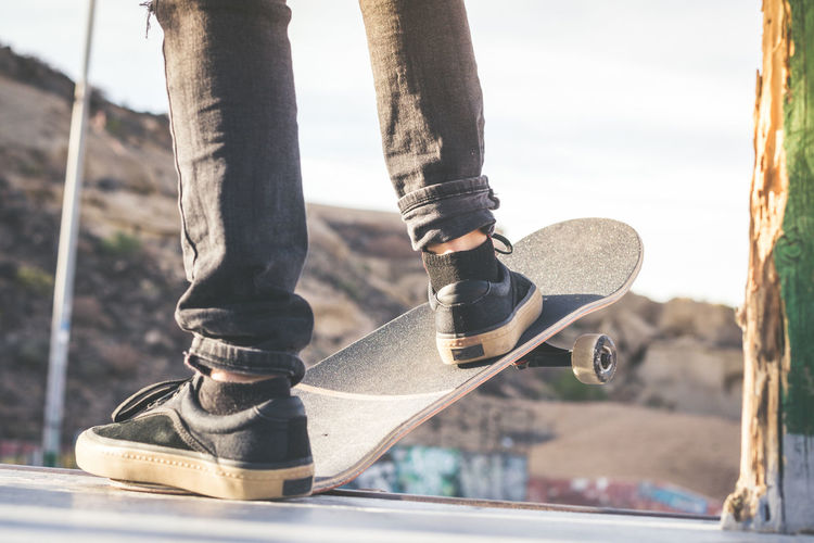 Low section of man with skateboard