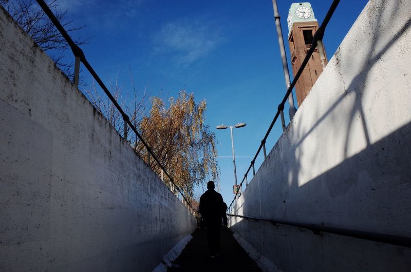 Rear view of man walking on steps