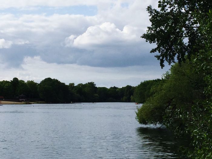 Scenic view of river against cloudy sky