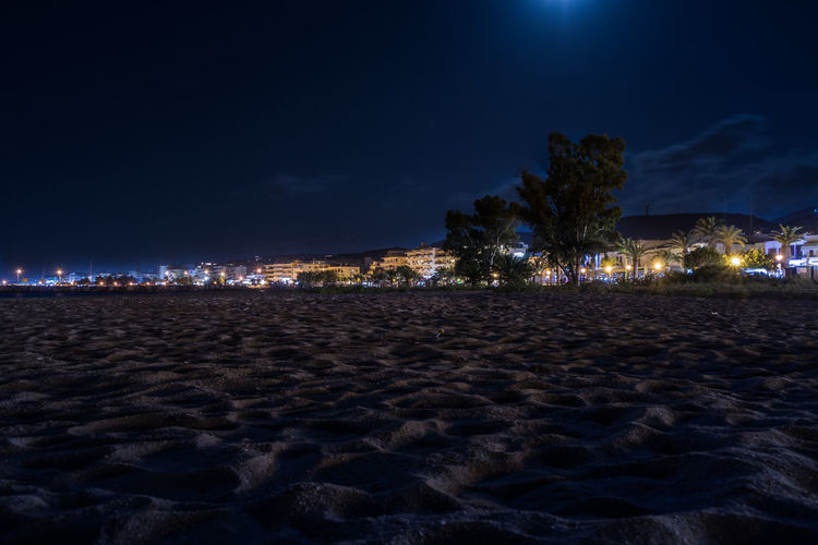 Surface level of beach with illuminated built structures