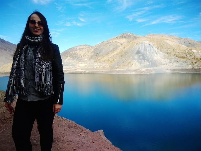Full length of man standing on lake against mountains